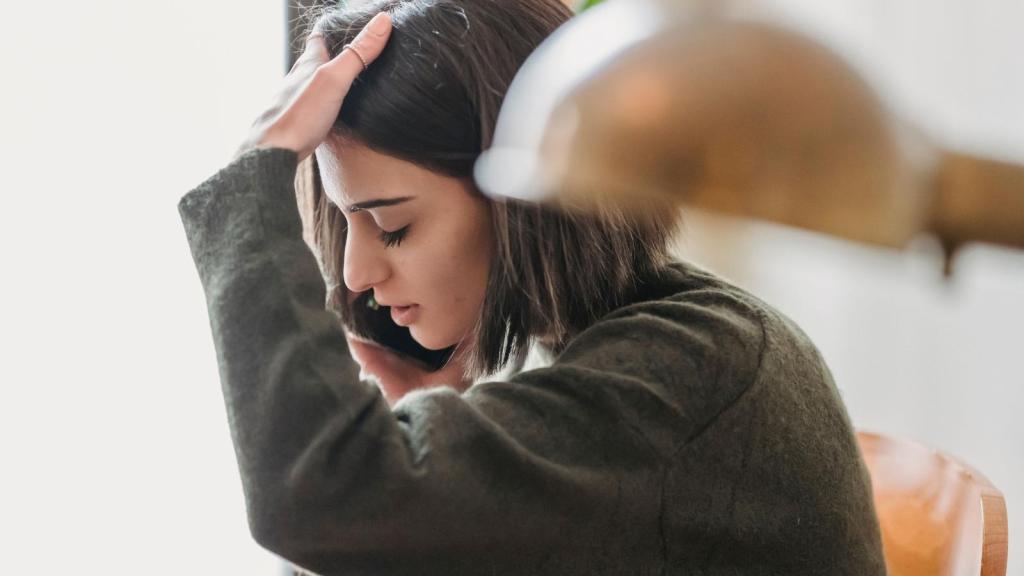 upset woman talking on her cell phone