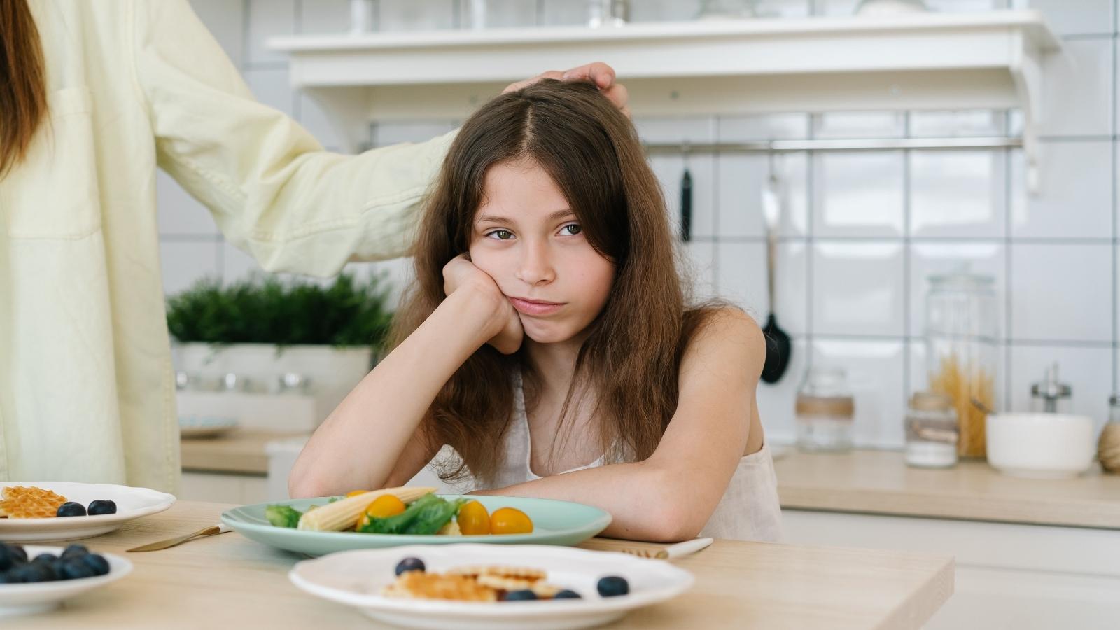 She Took In Her Late Friends Daughter Seven Months Ago—Now One Lie Has Pushed Her To The Limit upset young girl at the kitchen table