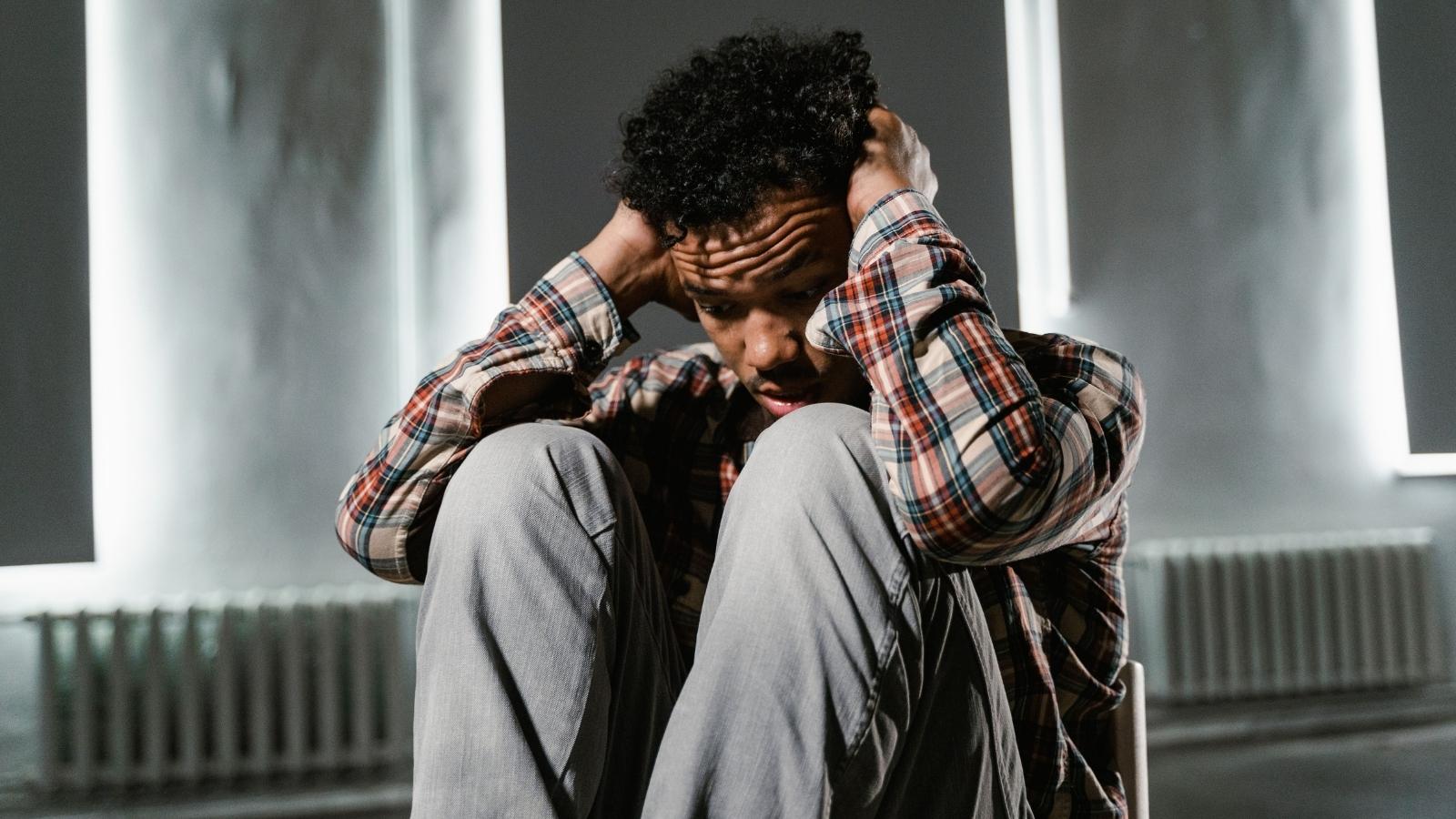 upset young man with hands over head