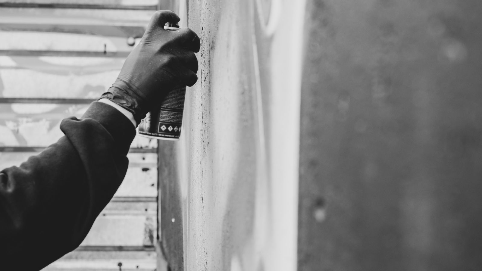 man vandalizing with spray paint