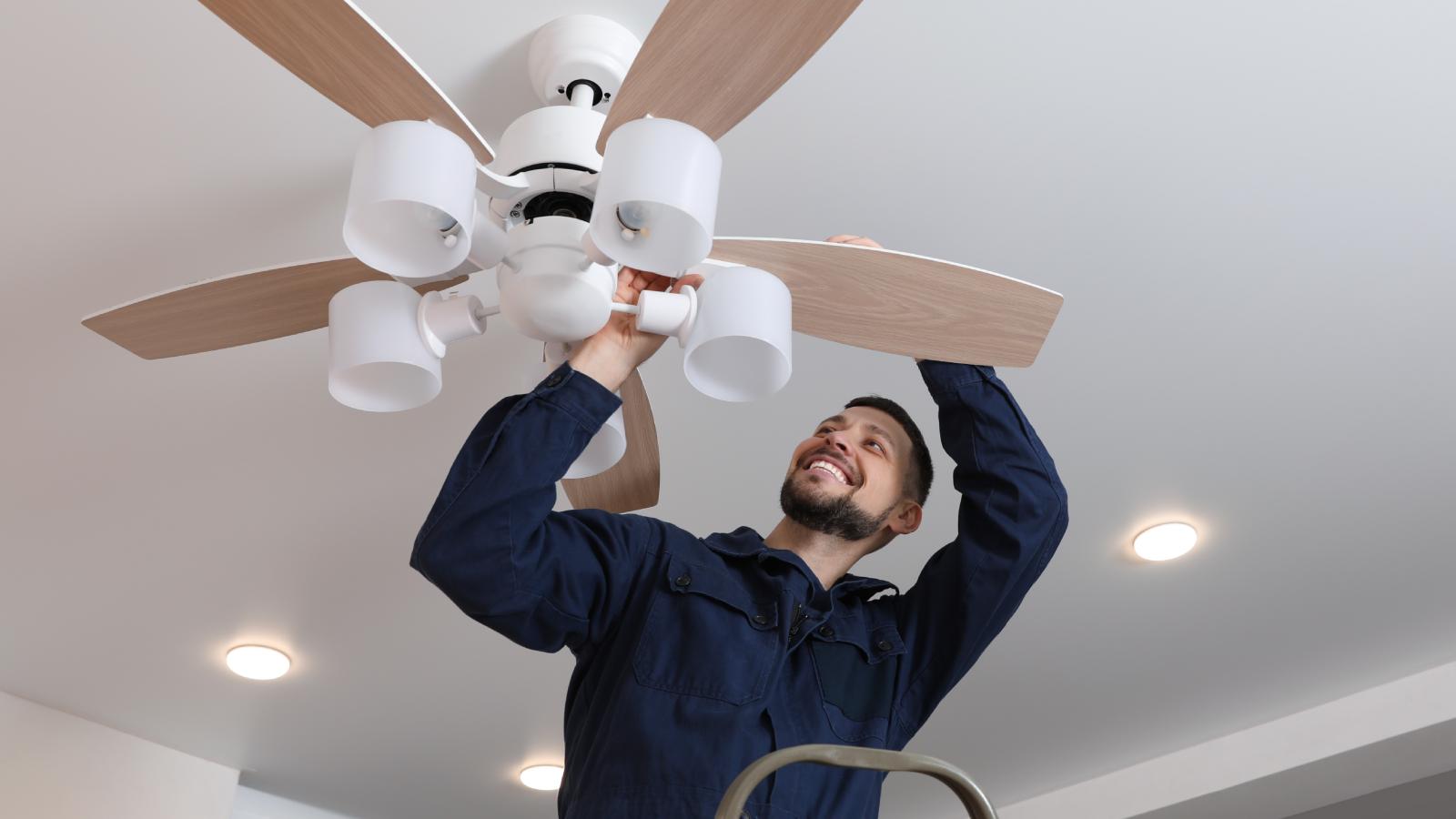 A Company Quoted Him Too Much to Install Ceiling Fans — So One of Their Own Employees Offered to Do It for Less man instaling a ceiling fan