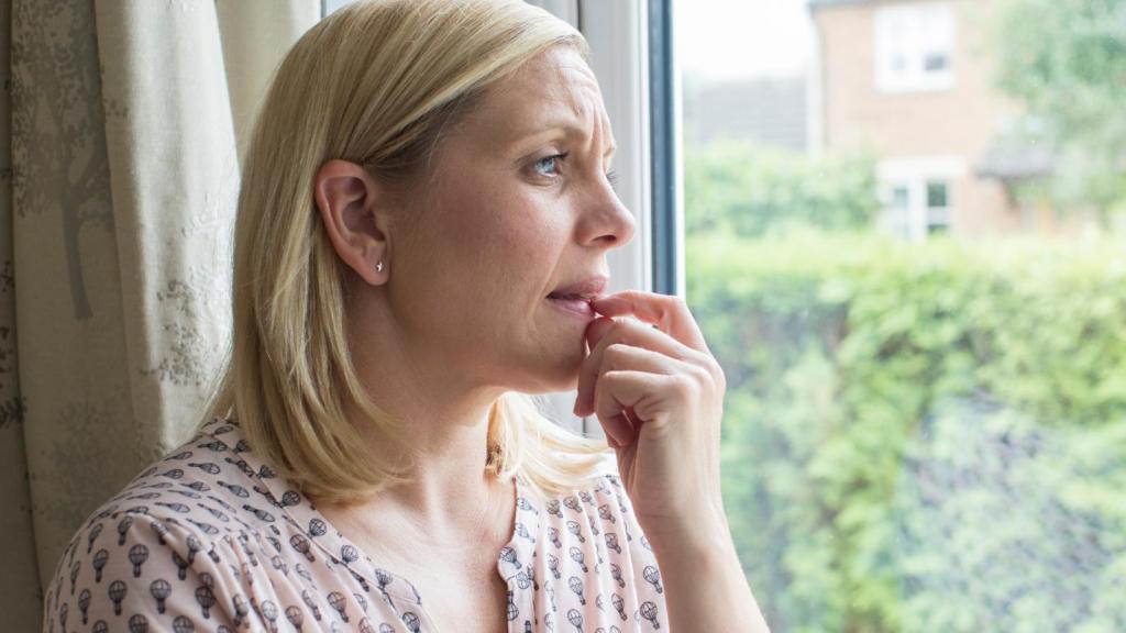 woman looking out a window
