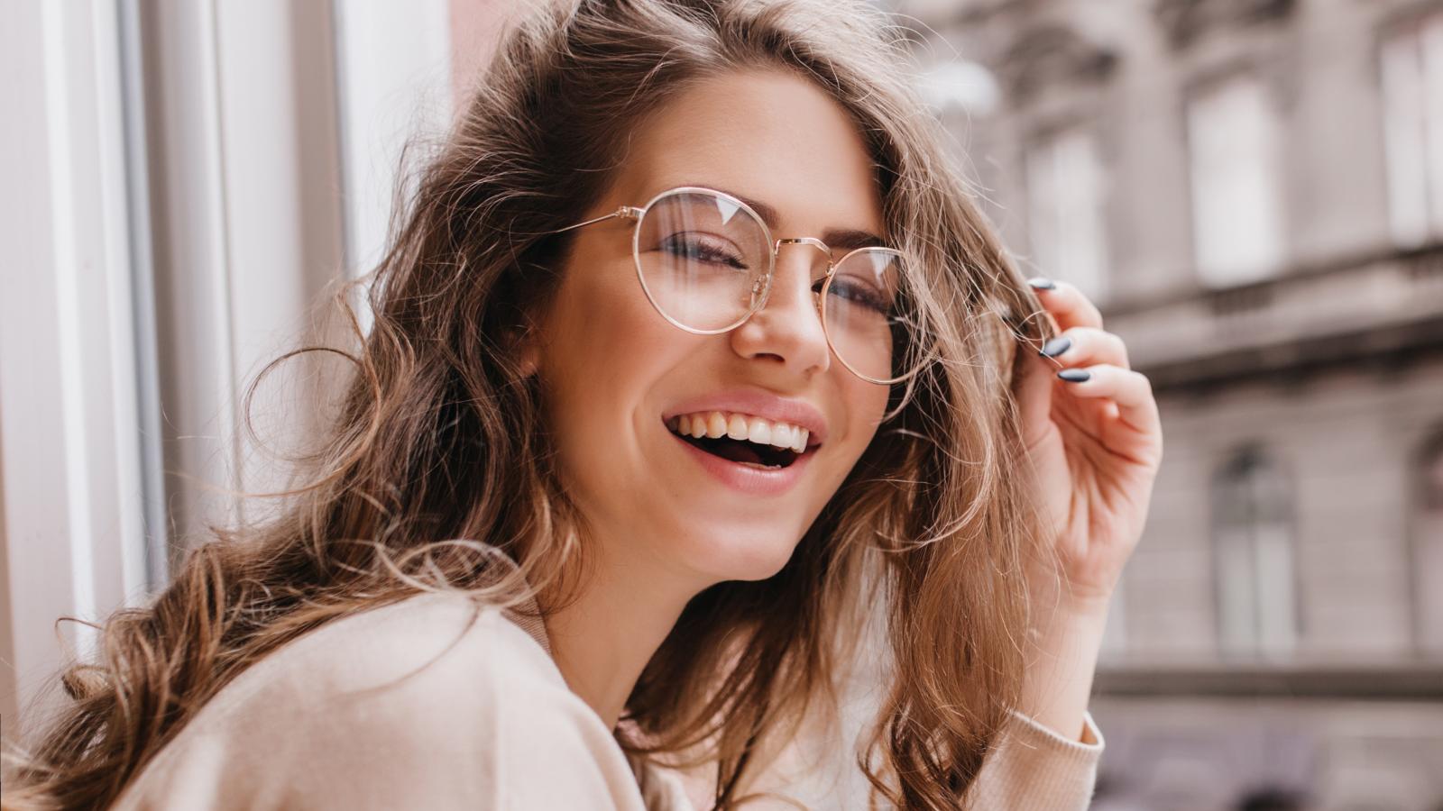 woman laughing by a window