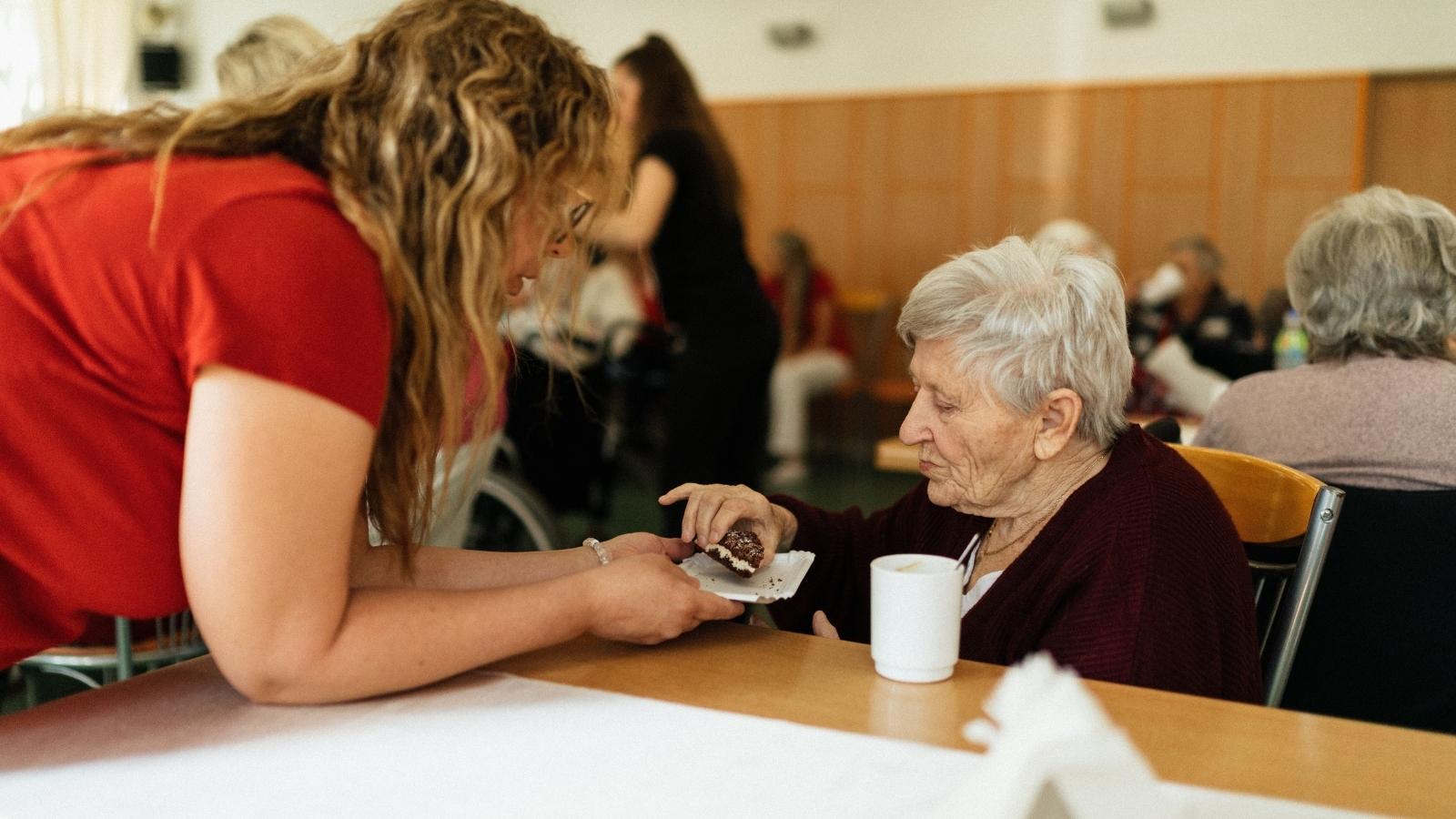 A Remote Employee Is Reeling After Her Company Weaponized a Relocation Order Against Her Family Care Setup woman caring for her aging mother