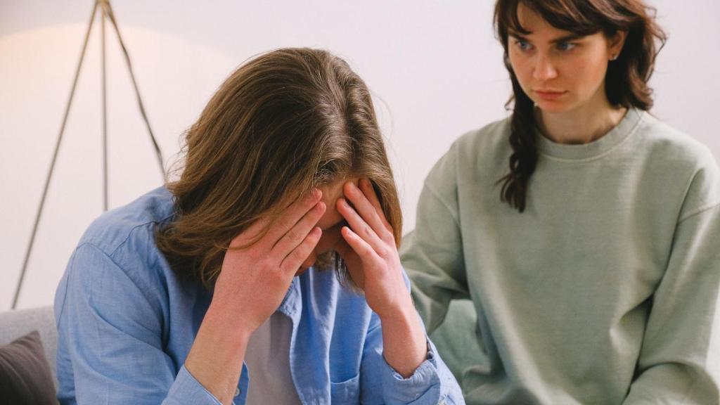 woman comforting her upset husband