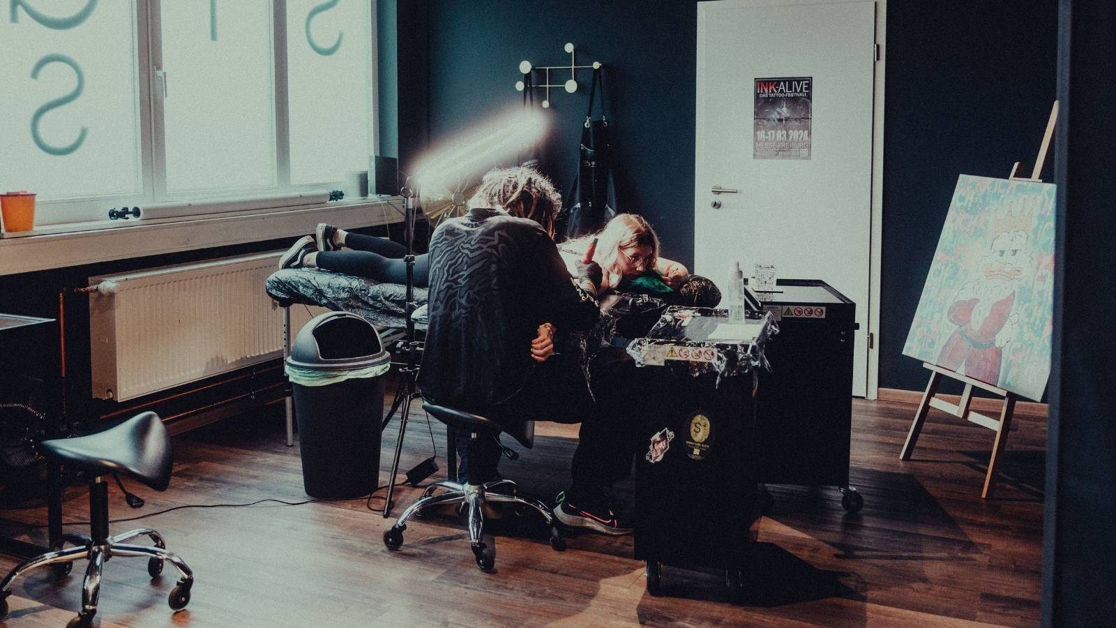 She Chose a Different Artist for Her New Tattoo—And Her Mother Accused Her of Being Disloyal to Her Sibling. woman getting a tattoo