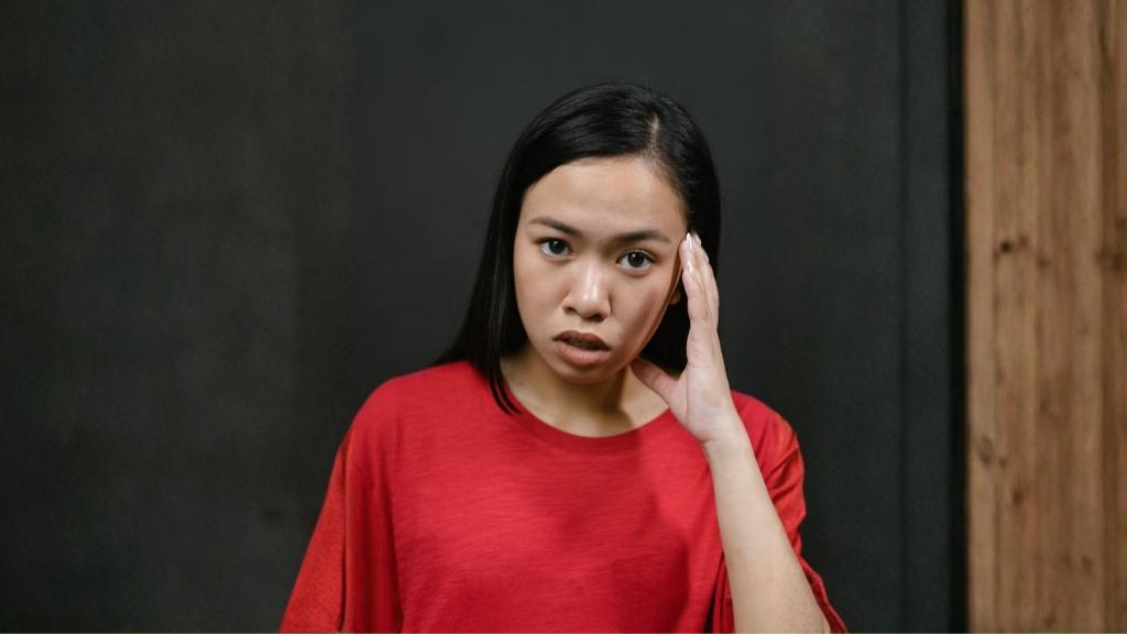 woman in red shirt with worried face
