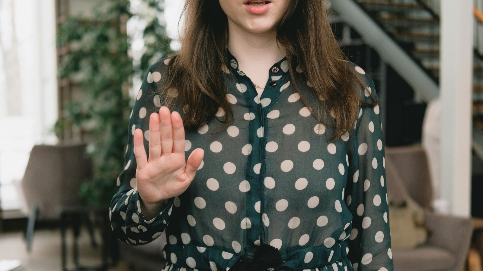 woman holding up a hand