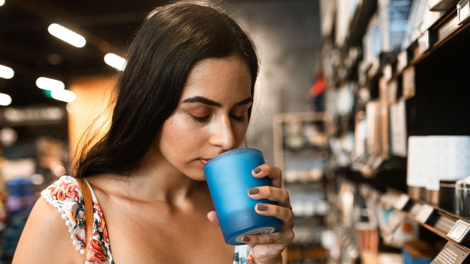 woman smelling candle in store