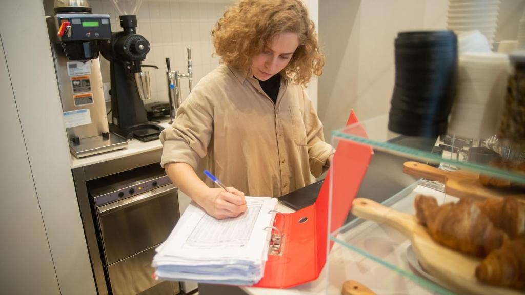 woman taking inventory in a bakery