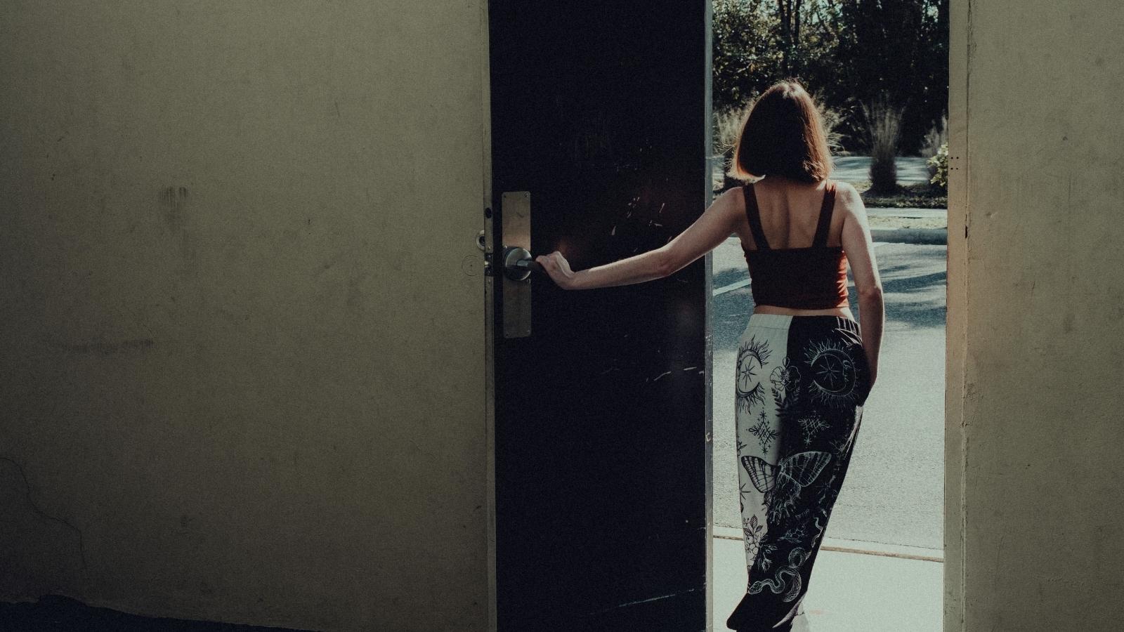 She Refused to Sit Through Her Siblings Self Centered Monologue. Now Her Family Is Using the Silent Treatment to Punish Her. woman walking out the door