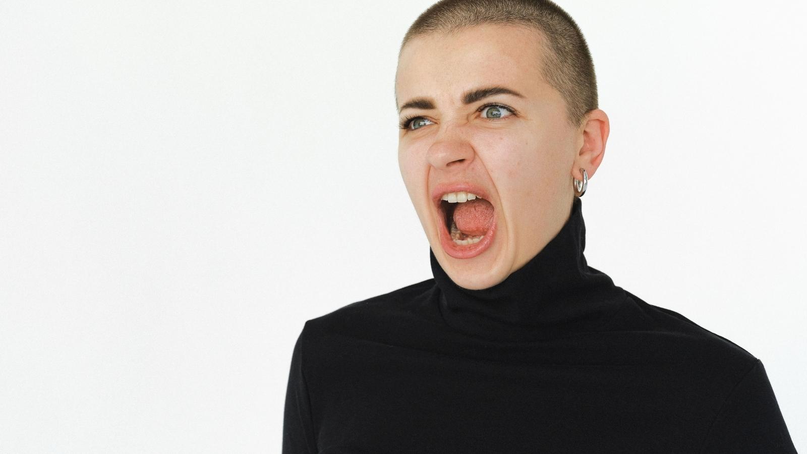 She Found Out Her Room Was Being Given to Her Sibling Before Shed Even Left for College, And She Started a Huge Fight About It woman with a buzzcut yelling