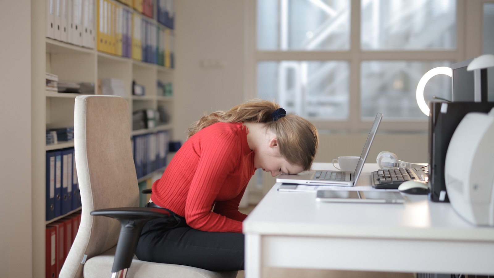 They Treated Her Like Dirt Until She Quit. Now, Her Miserable Bosses Are Desperate to Win Her Back. woman office worker banging her head on laptop/computer