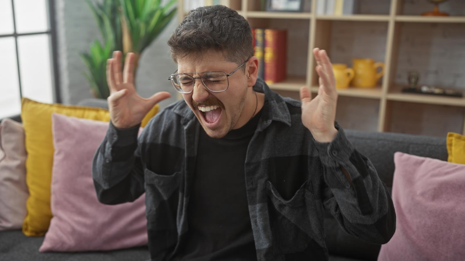 man yelling on a couch