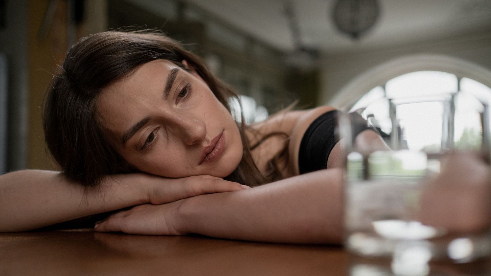 Sad woman lying on a table