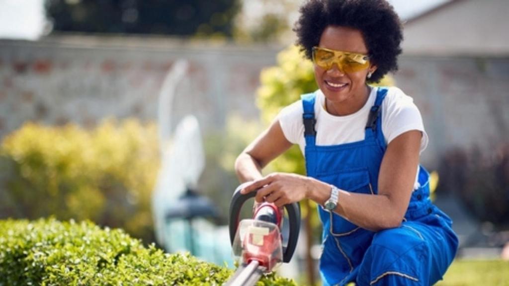 Woman trimming bushes