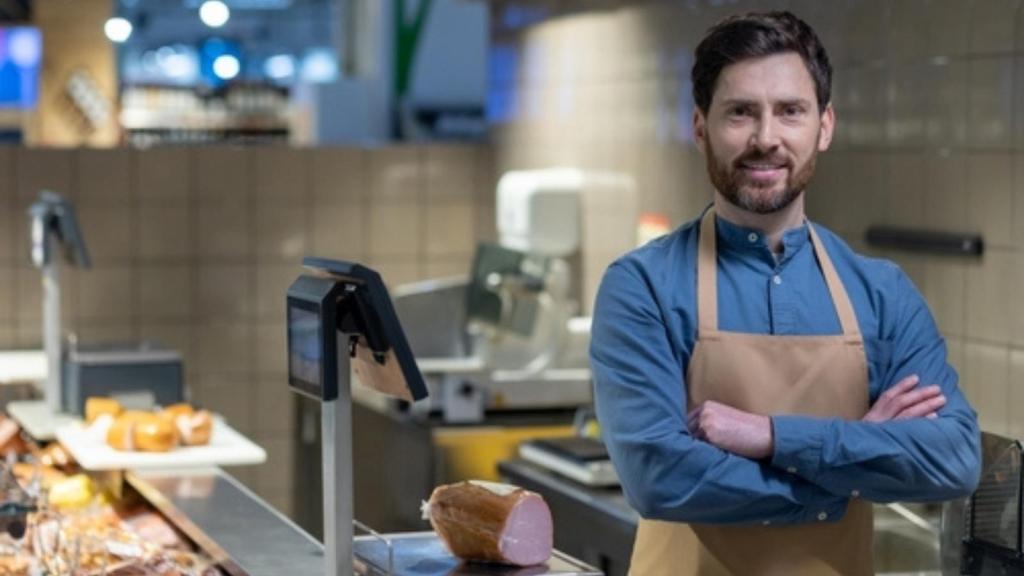 Man working at a butcher counter