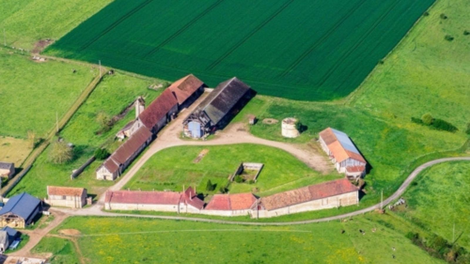 New Neighbors Complained About His Farm—So He Stopped Plowing Their Driveway for Them Aerial view of a farm