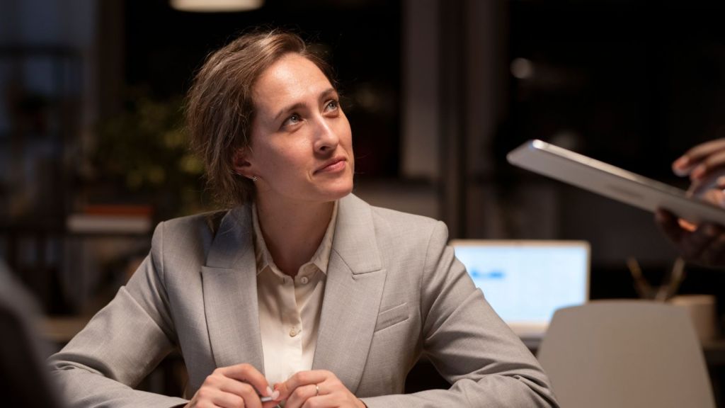 Female boss looking at an employee with a poker face