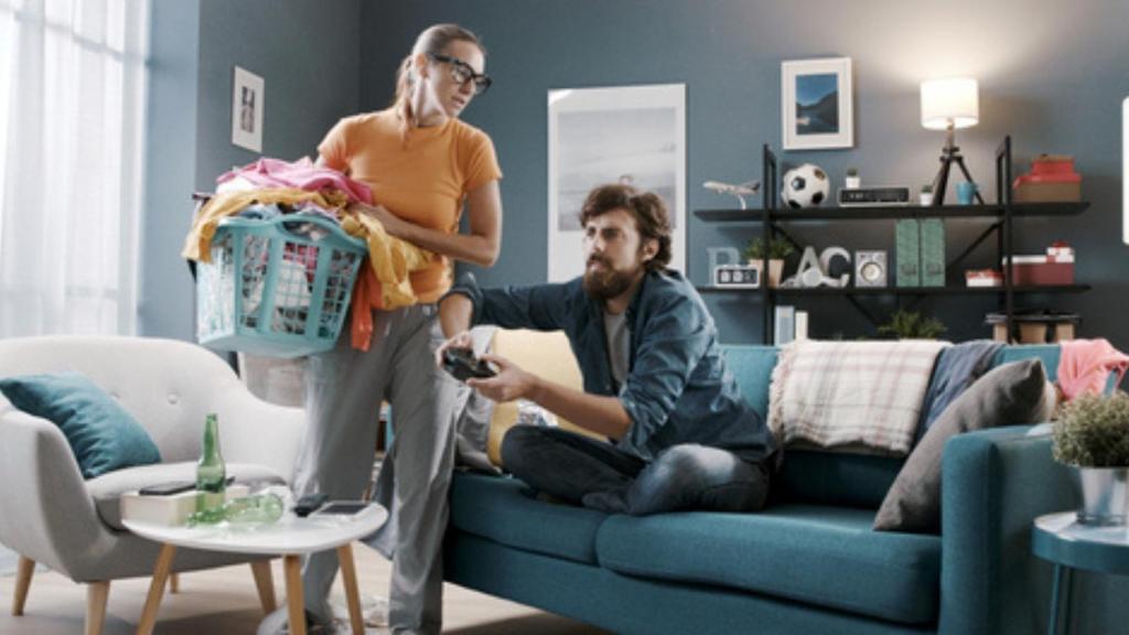 Woman cleaning man playing games