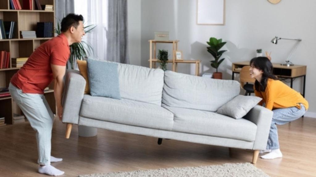 Couple moving furniture