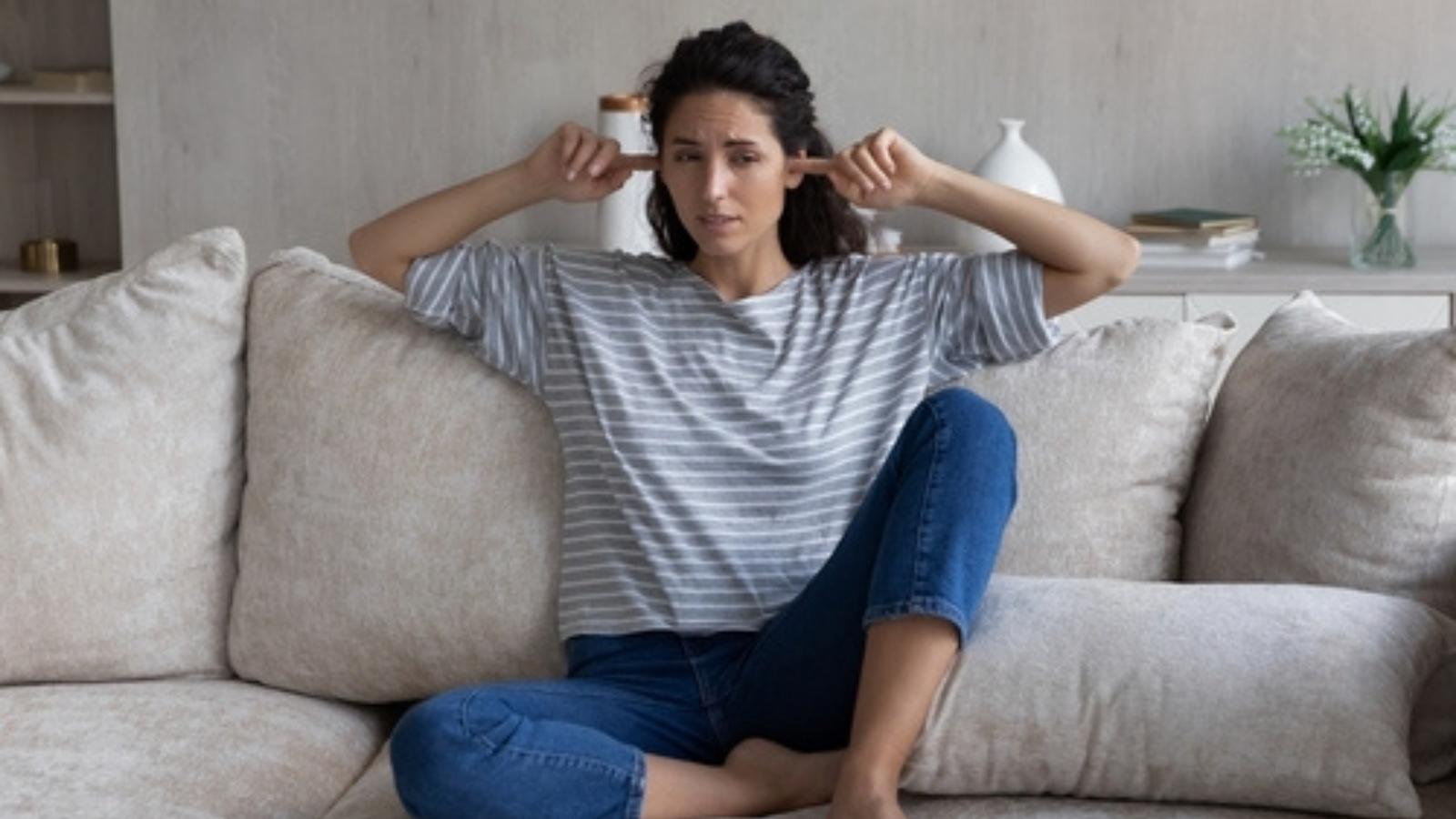 Woman with fingers in her ears