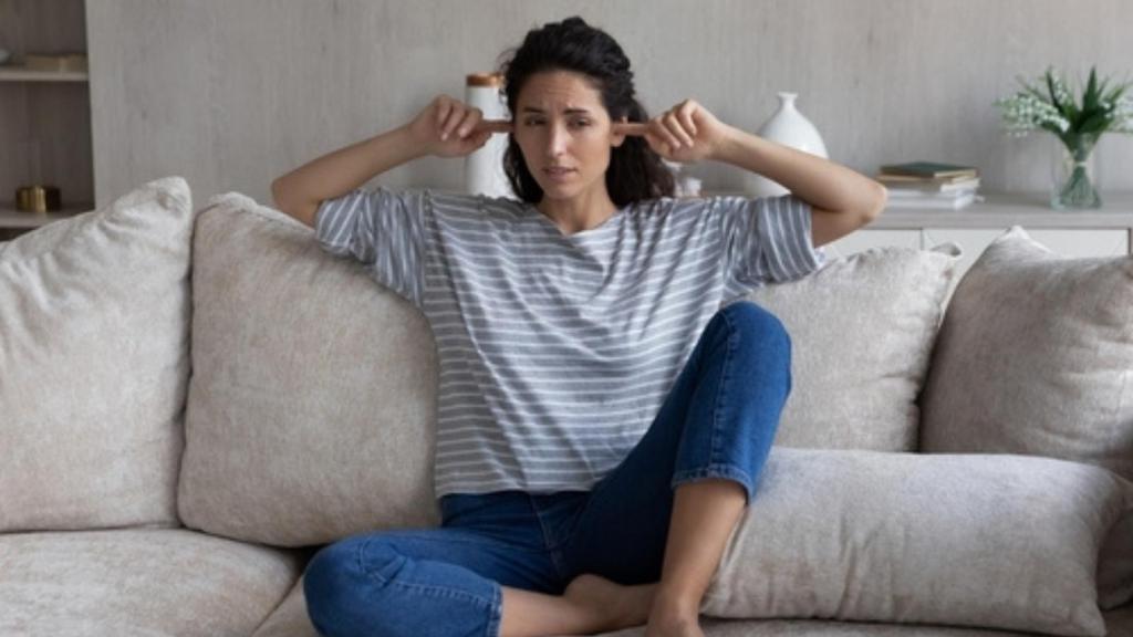 Woman with fingers in her ears