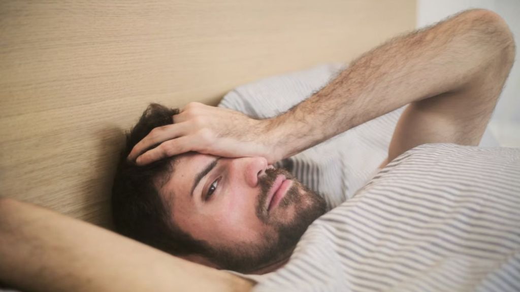 Man in bed waking up after sleep