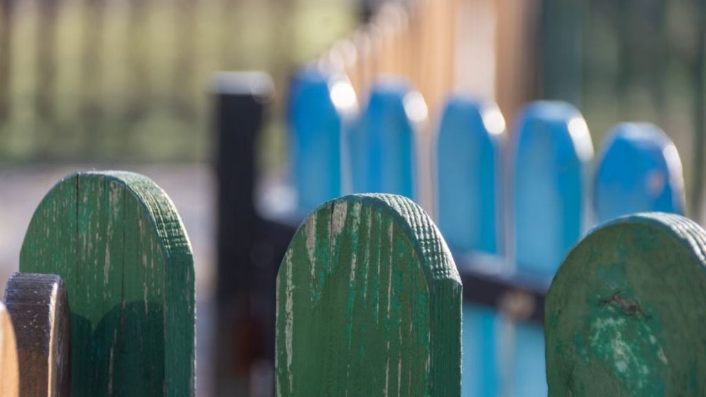 Property fence painted green and blue