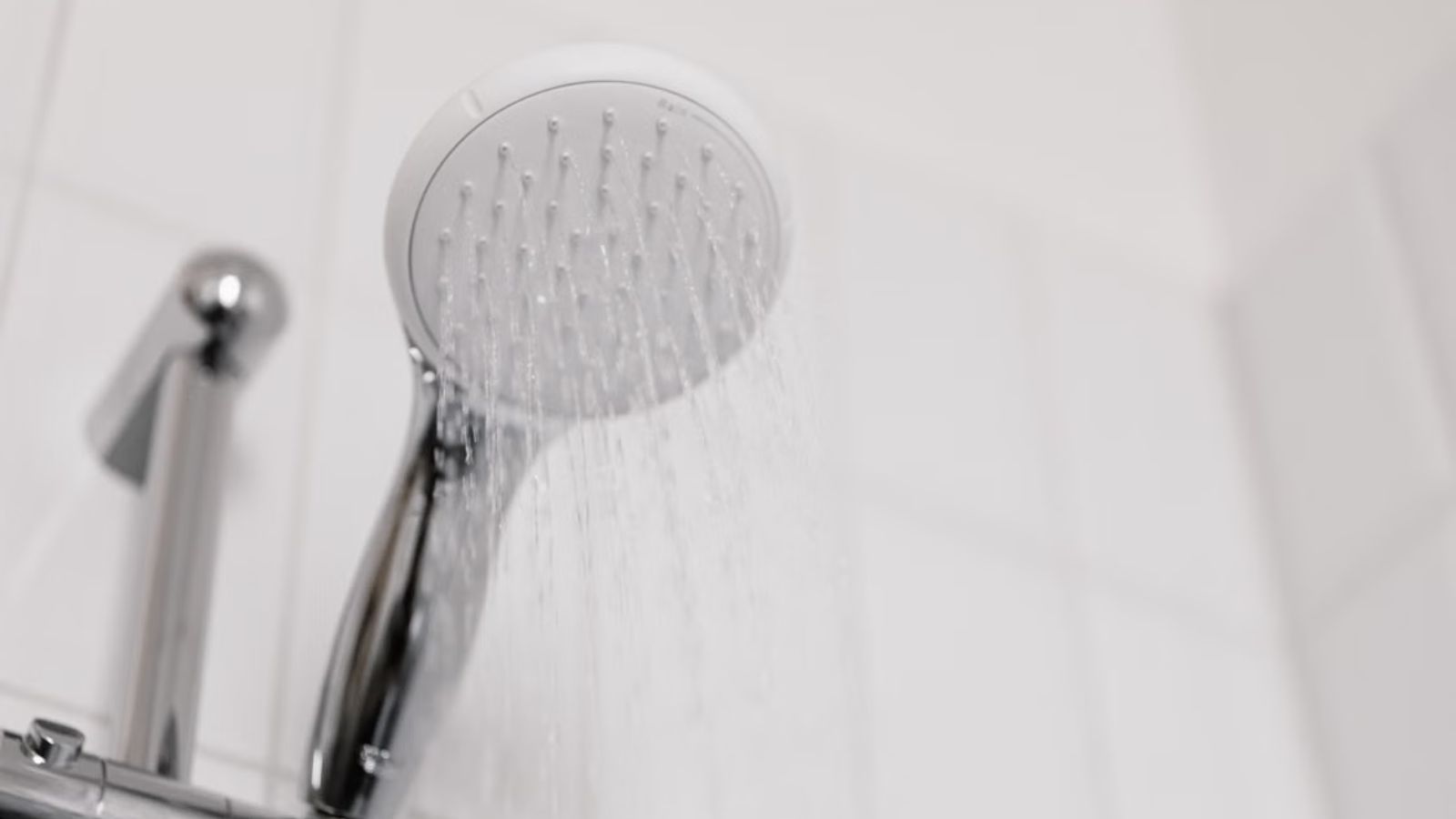 She Told Her Mom to Use the Broken Shower—and Accidentally Sparked a Massive Fight Between Her Parents Shower head pouring water inside the bathroom