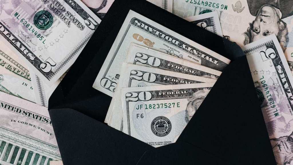 Black envelope with money sticking out