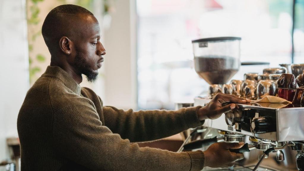 Man making coffee at a shop