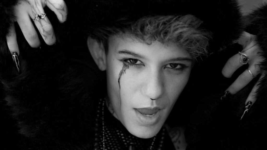 Gothic boy with long pointy nails in metal band