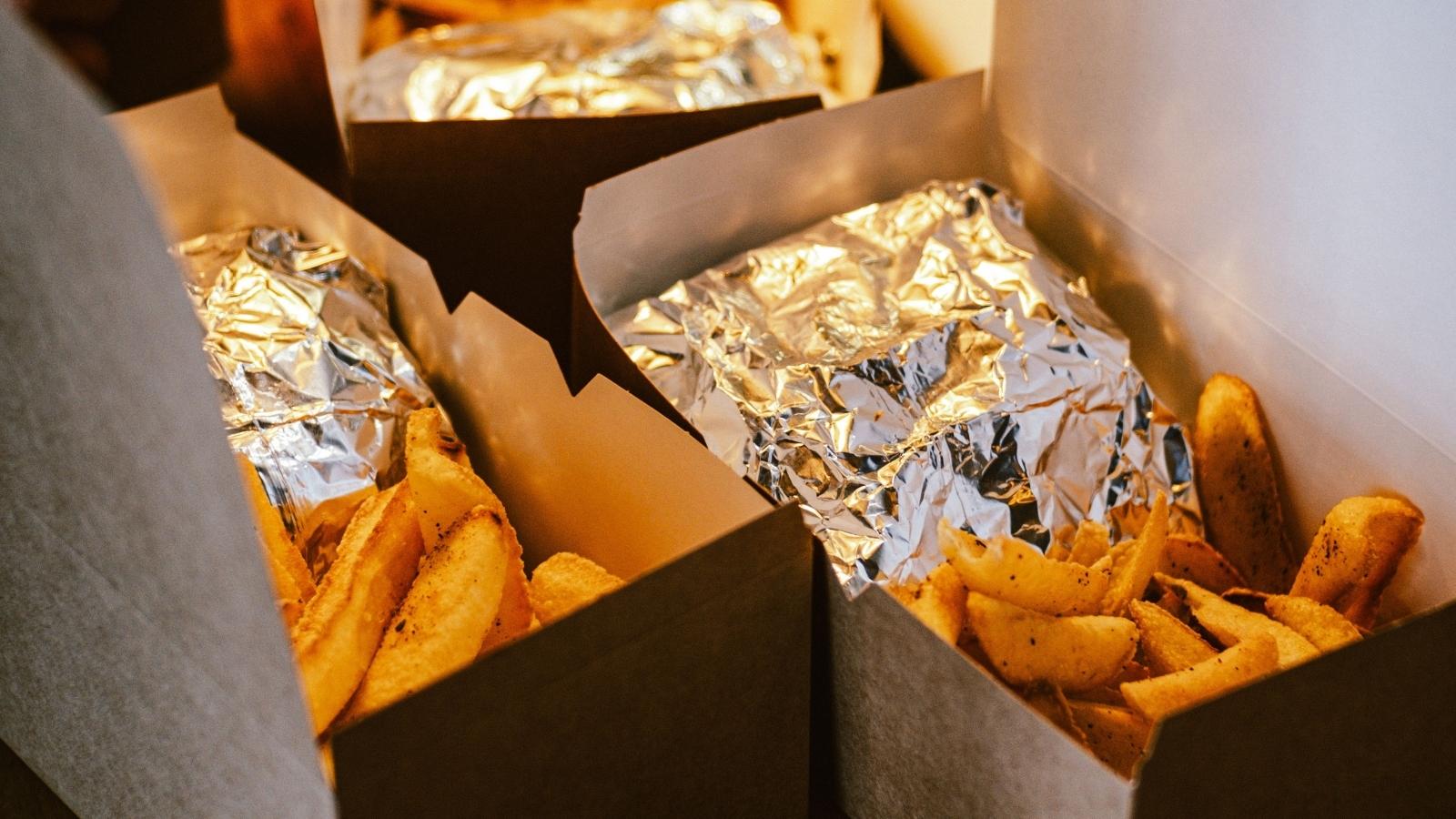 Boxes of take-out food opened and ready to eat