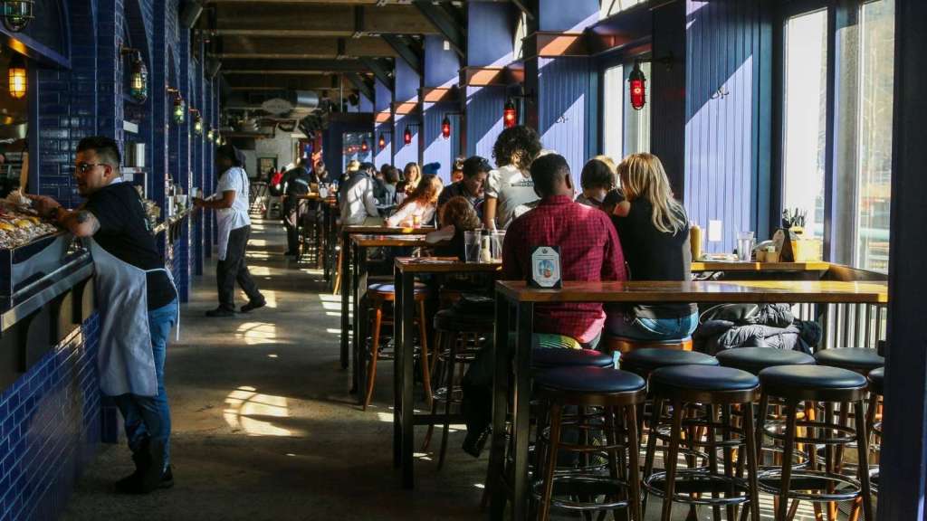 People enjoying meals at a sports bar