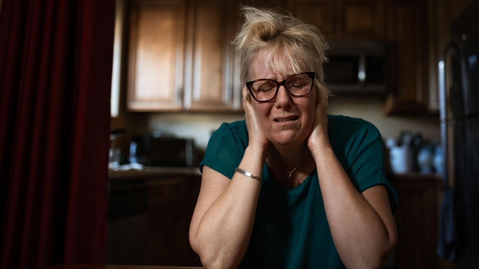 Her Upstairs Neighbor Has Been Yelling For Years—Now Fear Of Retaliation Keeps Her Silent Woman stressed over her neighbor's behavior