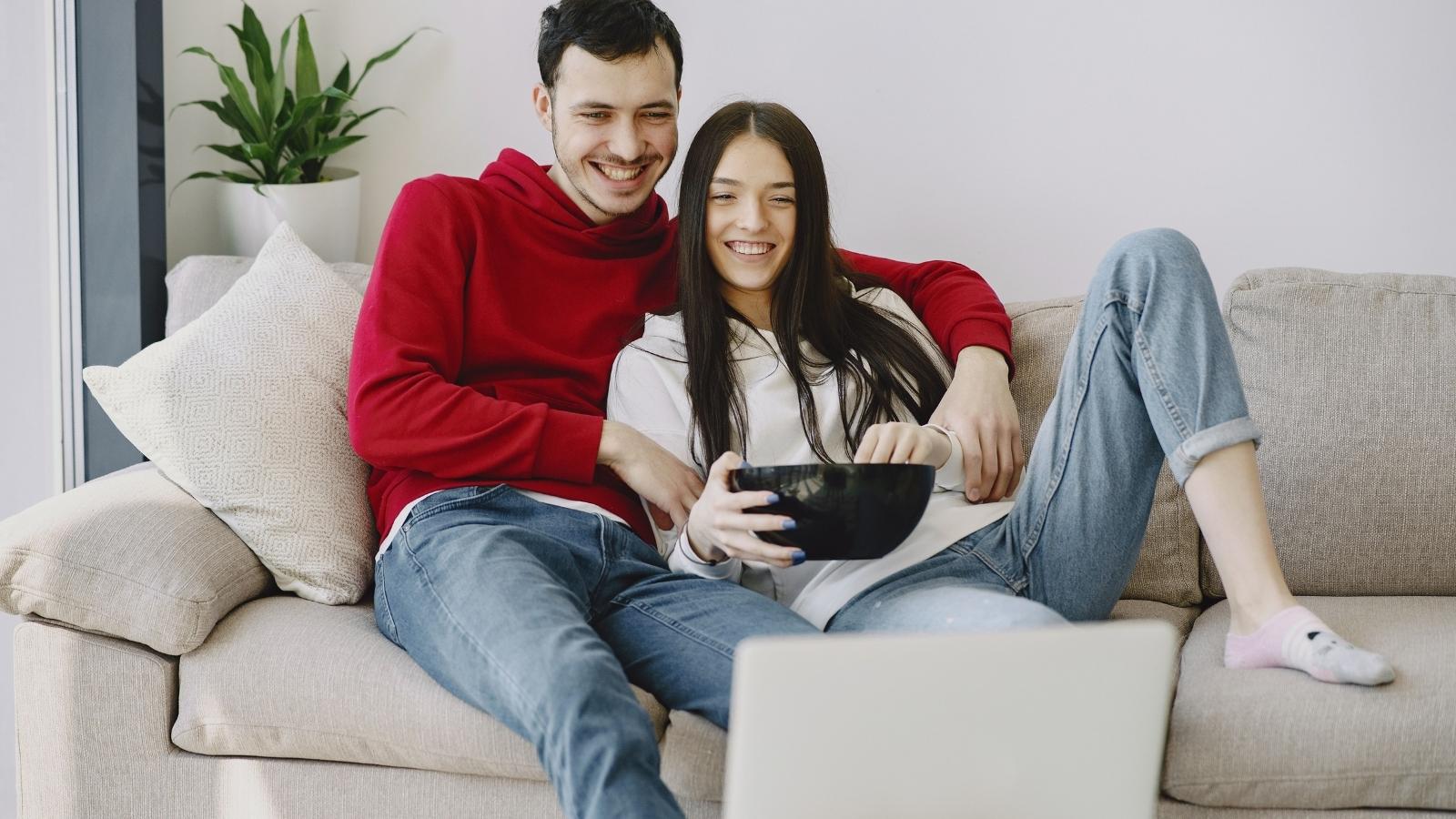 Will This Hurt Him?: Woman Faces Emotional Dilemma After Secretly Hating Fiancé’s Favorite Hobby Man and woman watching TV together.