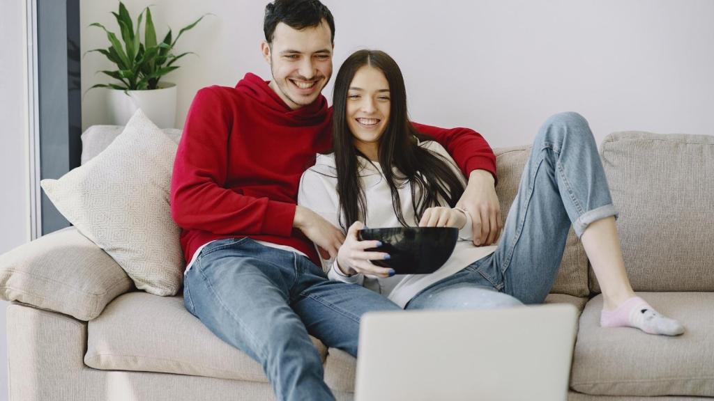 Man and woman watching TV together.