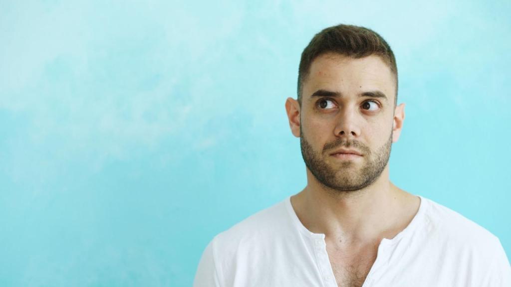 Man thinking about his situation against a blue background