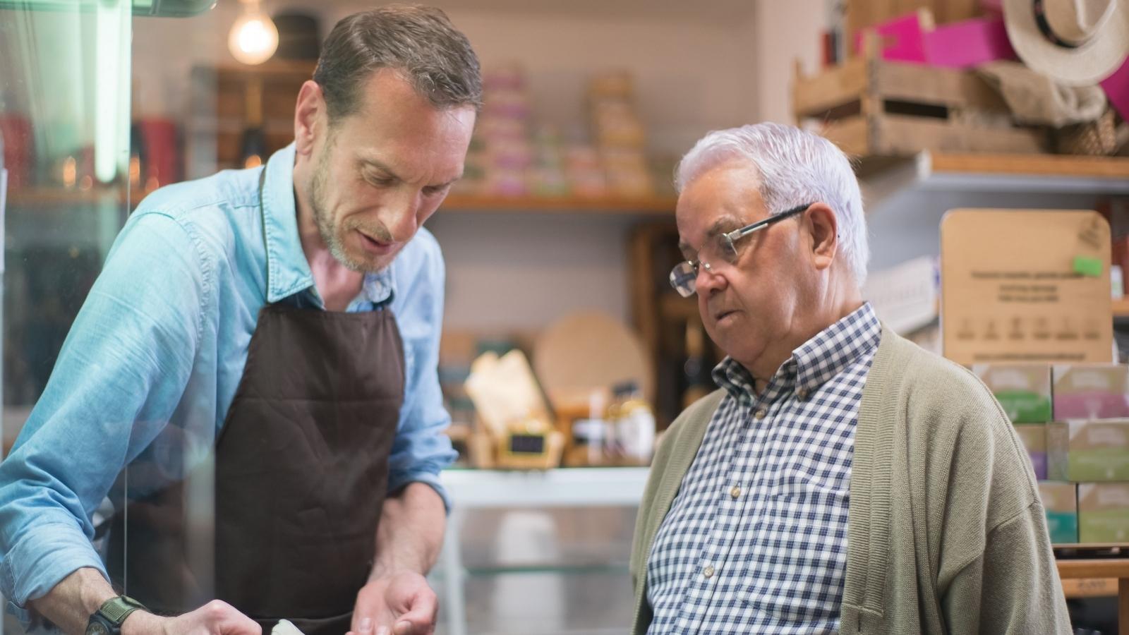 She Warned Him About the Restocking Fee Before He Bought — He Came Back the Next Day Demanding a Full Refund Anyway Man helping an older customer with a return
