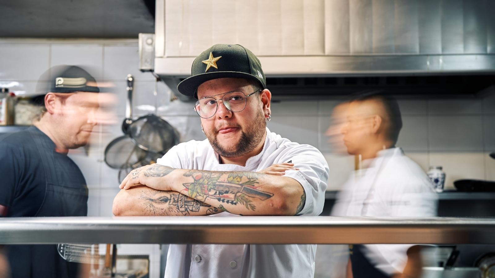 Back waiter standing in the kitchen thinking