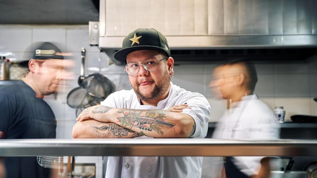 Back waiter standing in the kitchen thinking