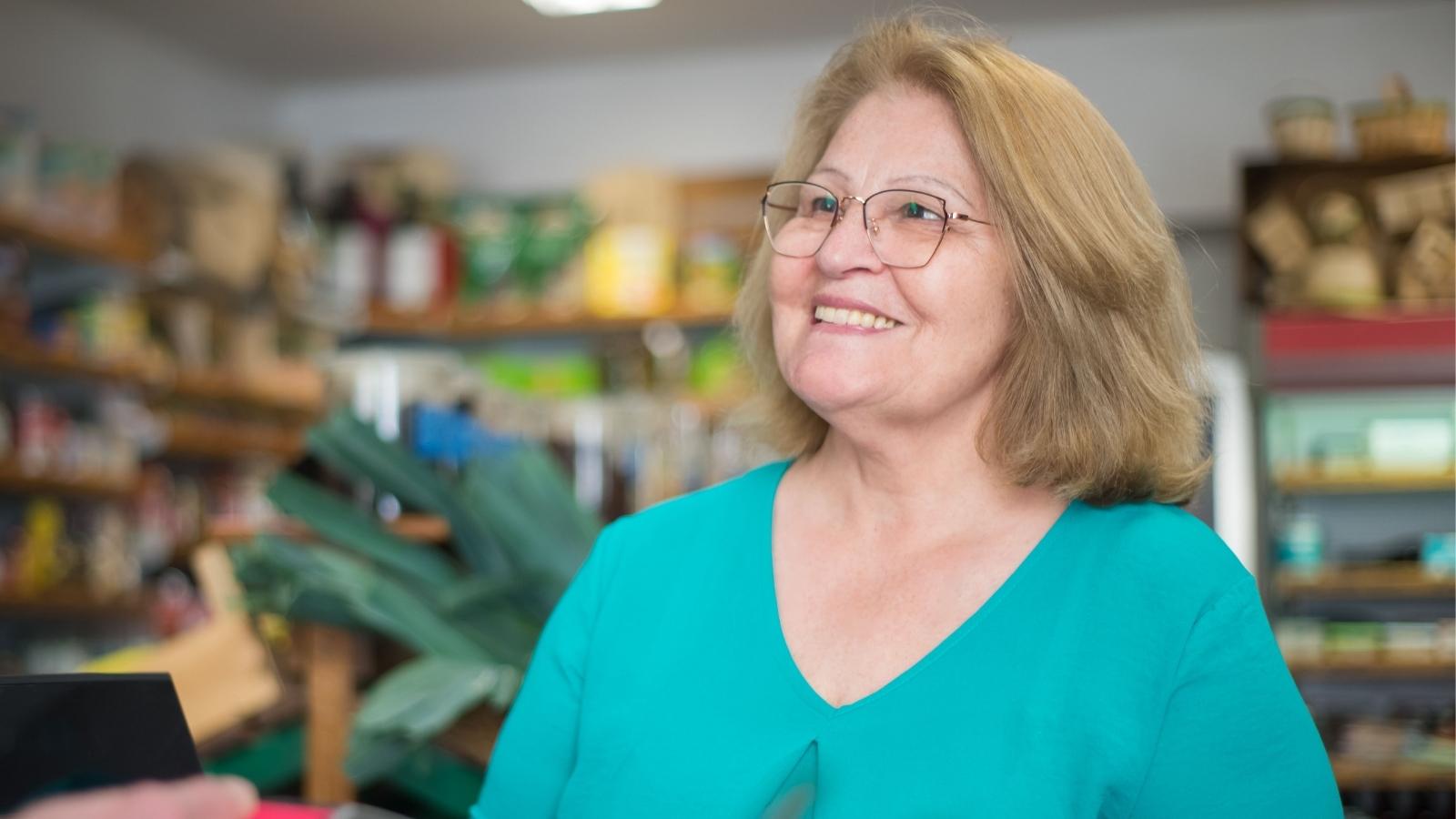 Older cashier working at a grocery store