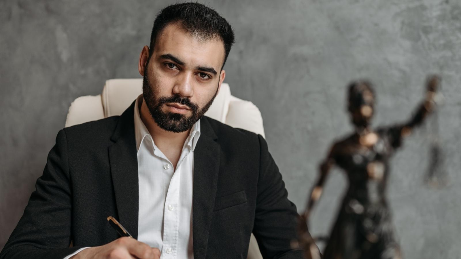 Man sitting in his desk chair visibly frustrated