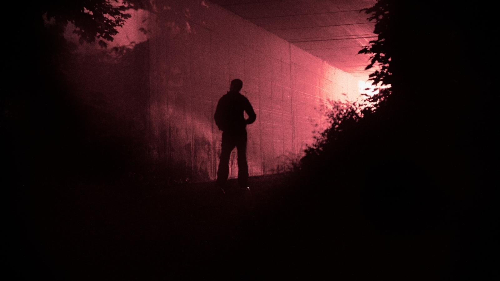 Creepy man standing in the shadows