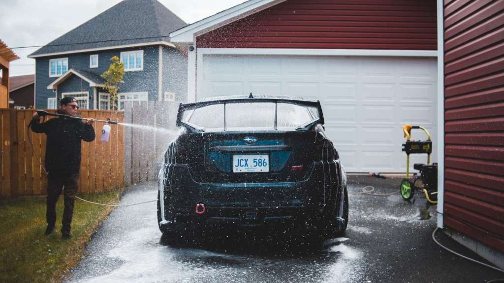 Man washing his car at 7:30 AM