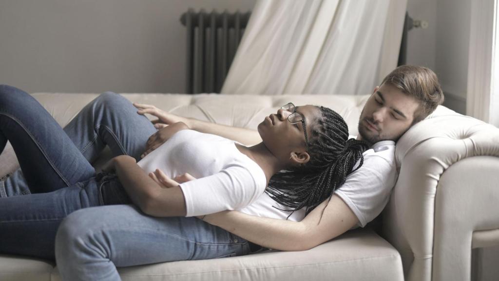 Man holding his GF while she sleeps off a migraine