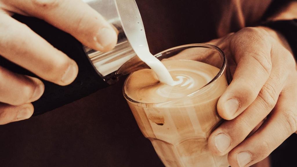Man making coffee with caramel and cream