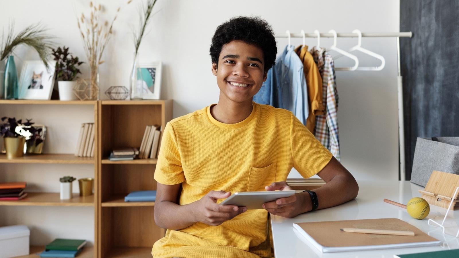 There’s Nothing to Eat!: Teen Ignores Fully Stocked Kitchen—Then DoorDashes Dunkin Out of Pure Spite Teen boy smiling after ordering food on DoorDash
