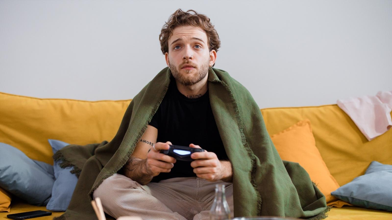 He Wanted His 30 Year Old Brother to Become Independent—So He Started Cutting Off His Comforts 30-year-old man playing video games at home